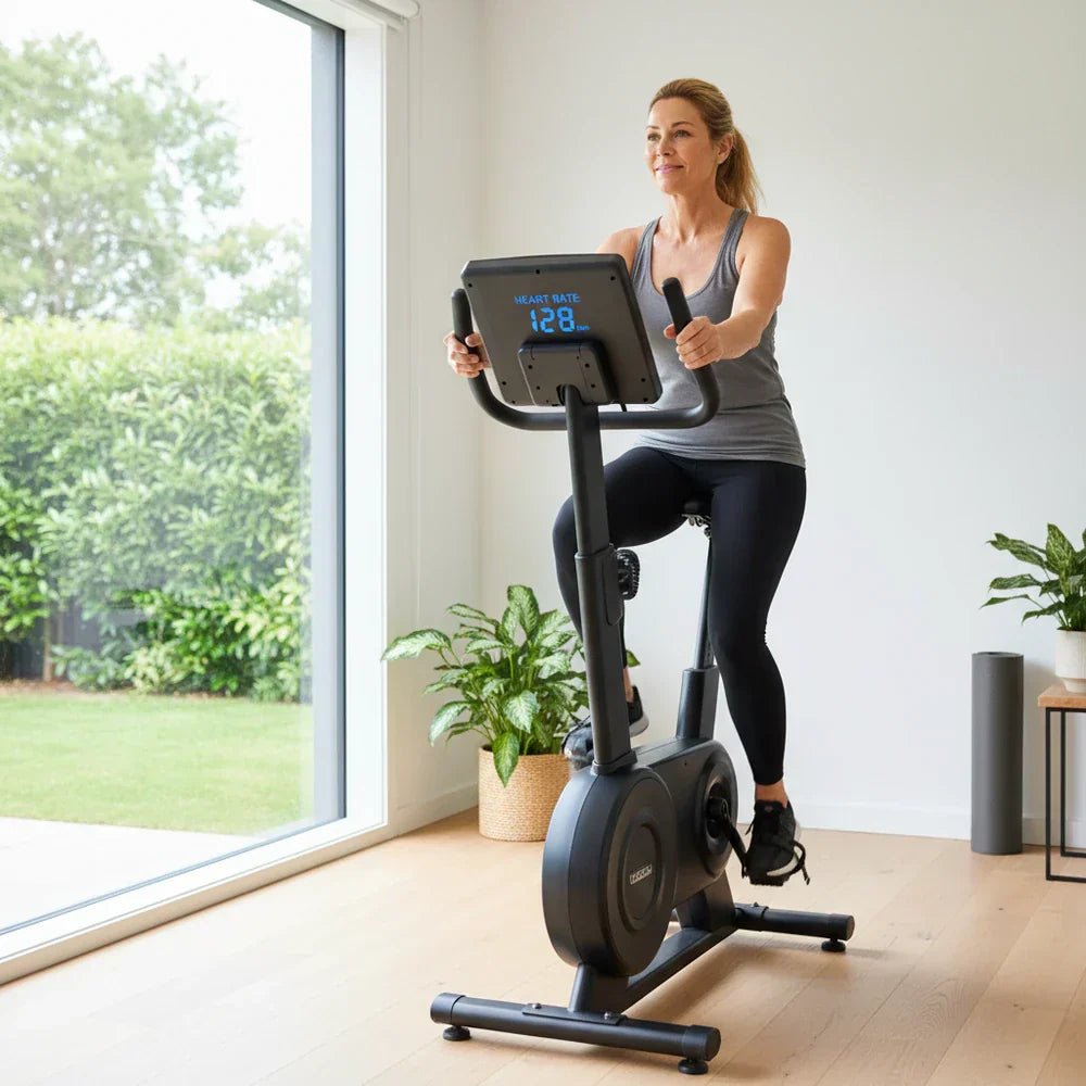 Person riding an exercise bike in zone 2 heart rate training
