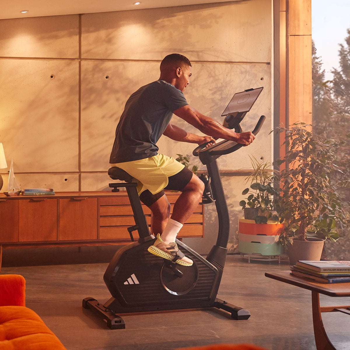 User selecting workout options on a fitness bike with digital display.