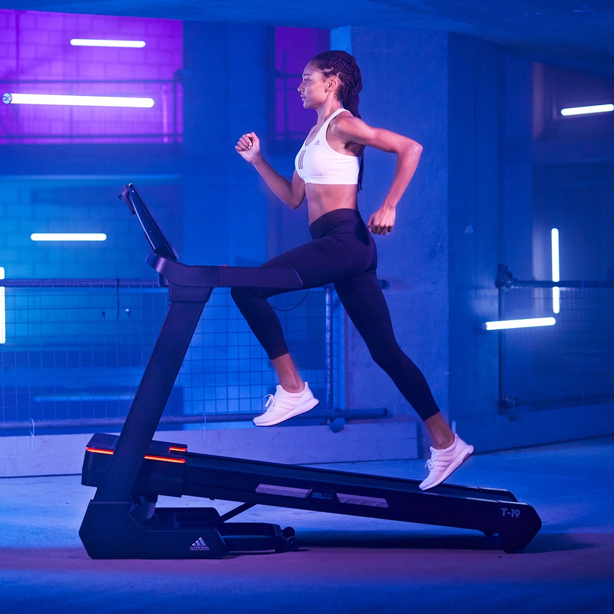 Adidas T-19 Treadmill console featuring a digital display, control panel with speed and program settings, and integrated speakers, designed for home fitness enthusiasts.