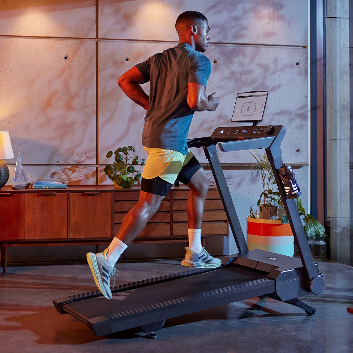 Adidas T24c Folding Treadmill in a modern interior, featuring a sleek design, digital display, and space-saving foldable capability, ideal for home workouts and fitness enthusiasts.