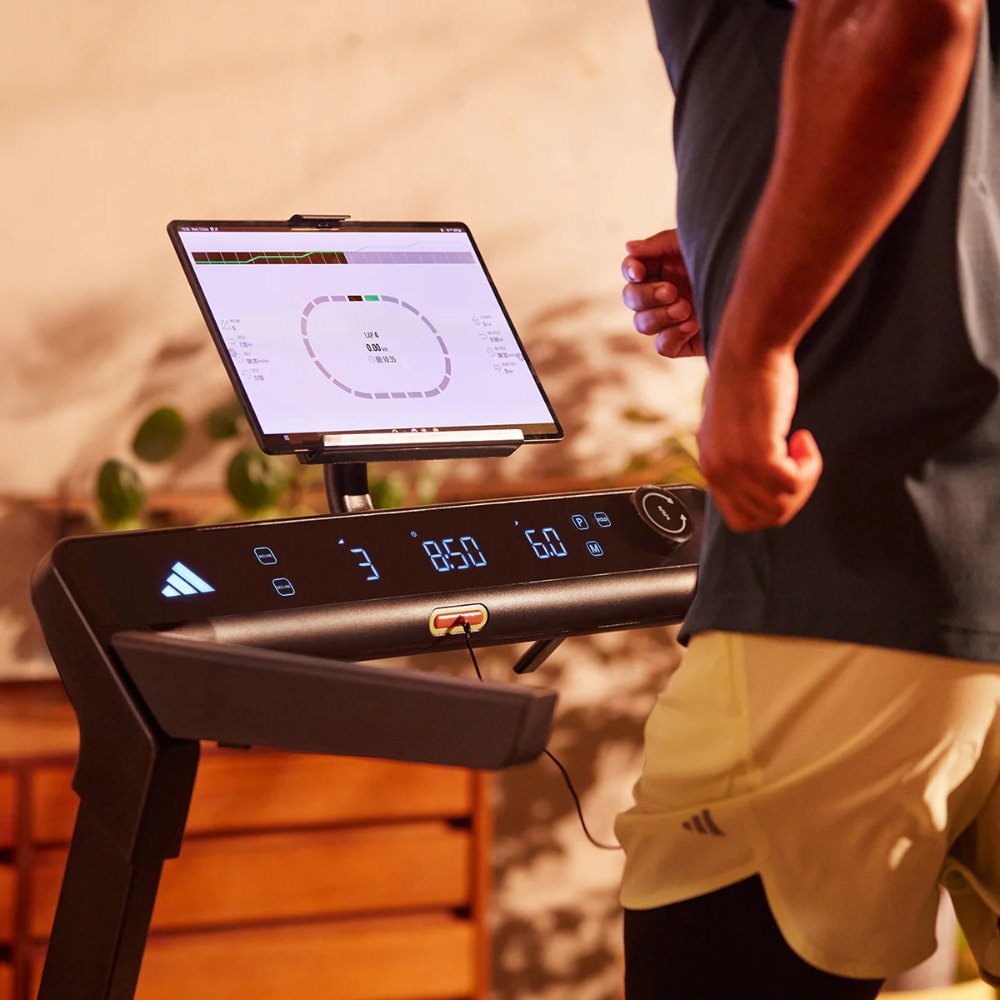 Home treadmill with digital display and adjustable settings for fitness enthusiasts