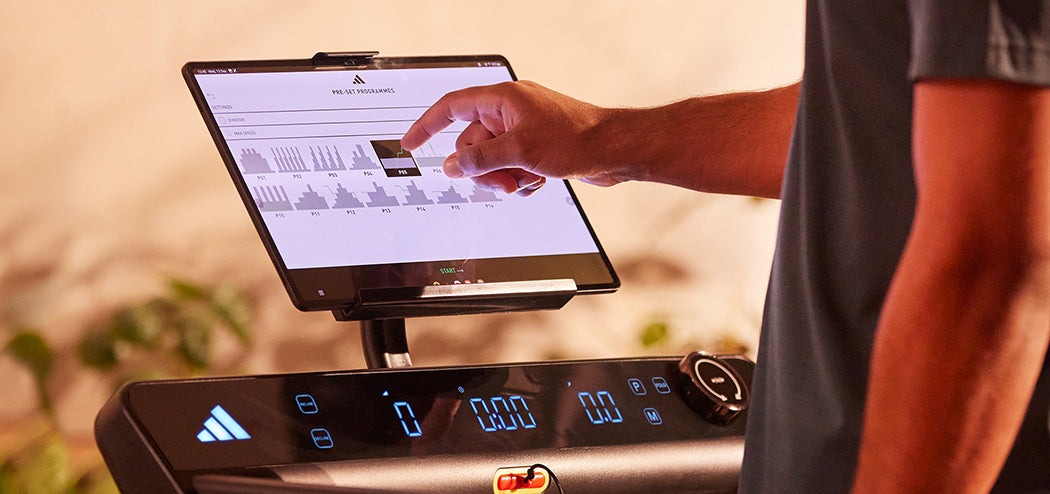 Adidas T24c Folding Treadmill with LED display, featuring a tablet for app integration showcasing Zwift and Kinomap.