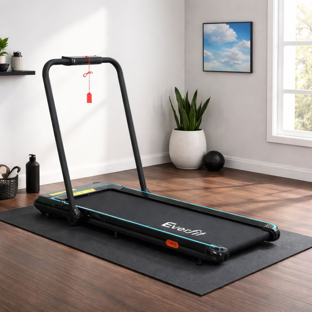 Compact Everfit treadmill on a black mat in a bright home setting