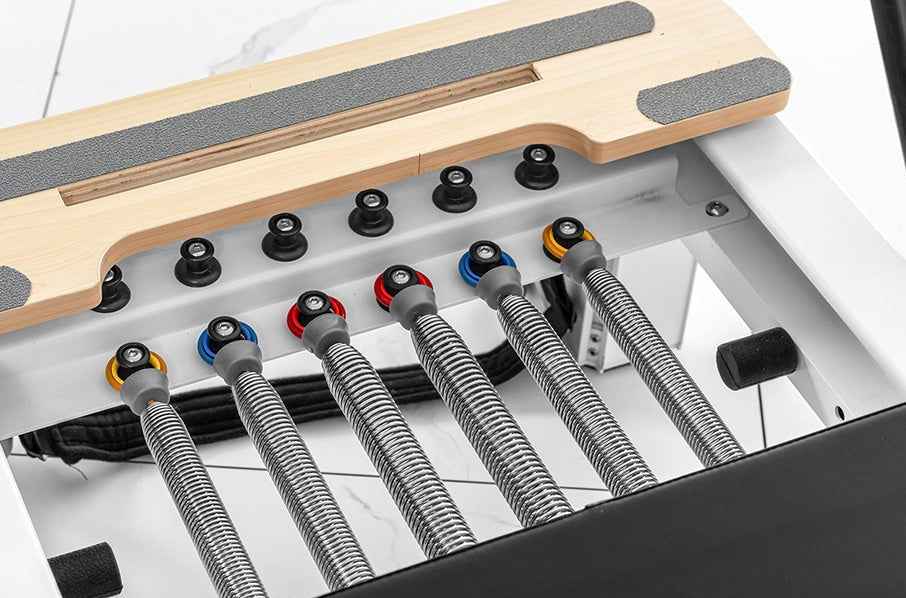 Lifespan Fitness Contour Studio Commercial Pilates Reformer Bed Set showcasing adjustable resistance springs for personalized Pilates workouts.