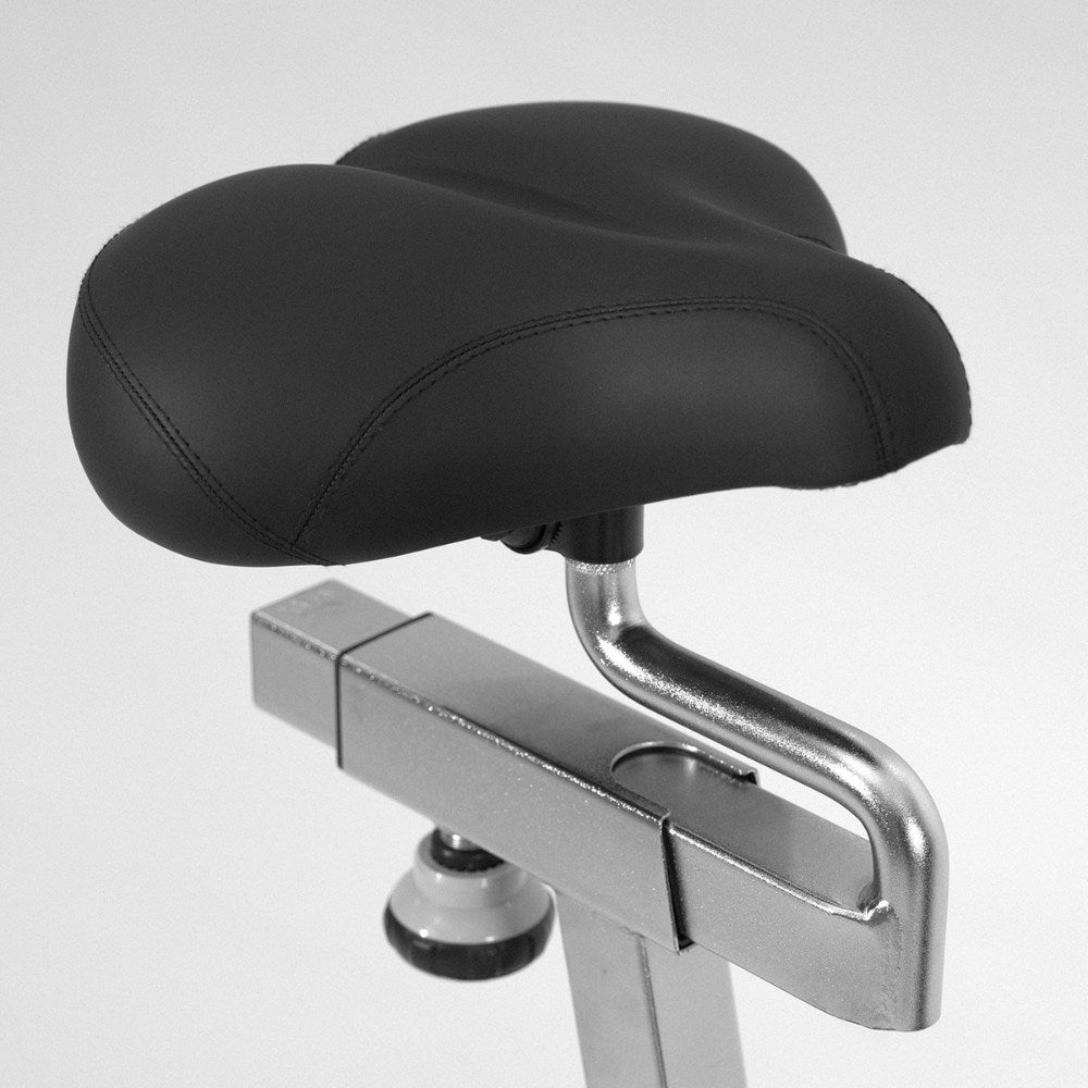 Man walking with a mobile exercise bike in a modern living room