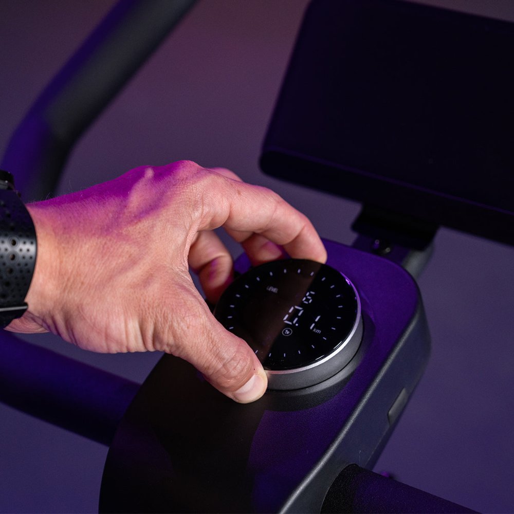 Lifespan Fitness SM420 Spin Bike with a clear multifunctional LCD display, tracking workout metrics during a session.