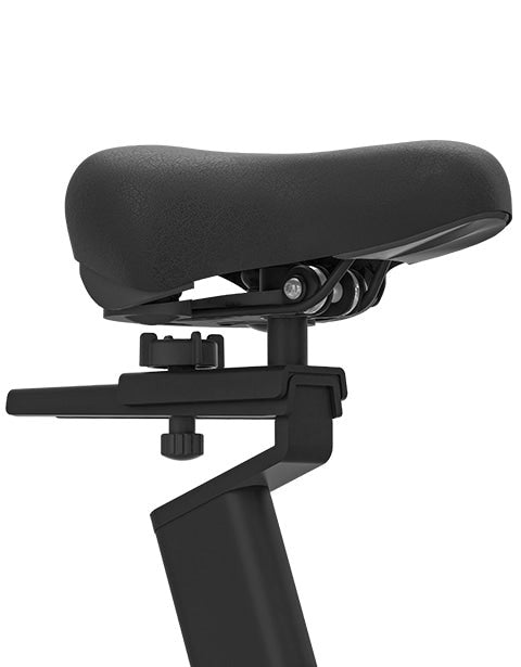 Close-up of a user pressing the red stop button on the Lifespan Fitness SM720i Spin Bike, designed for effective indoor cycling workouts with incline and decline features.