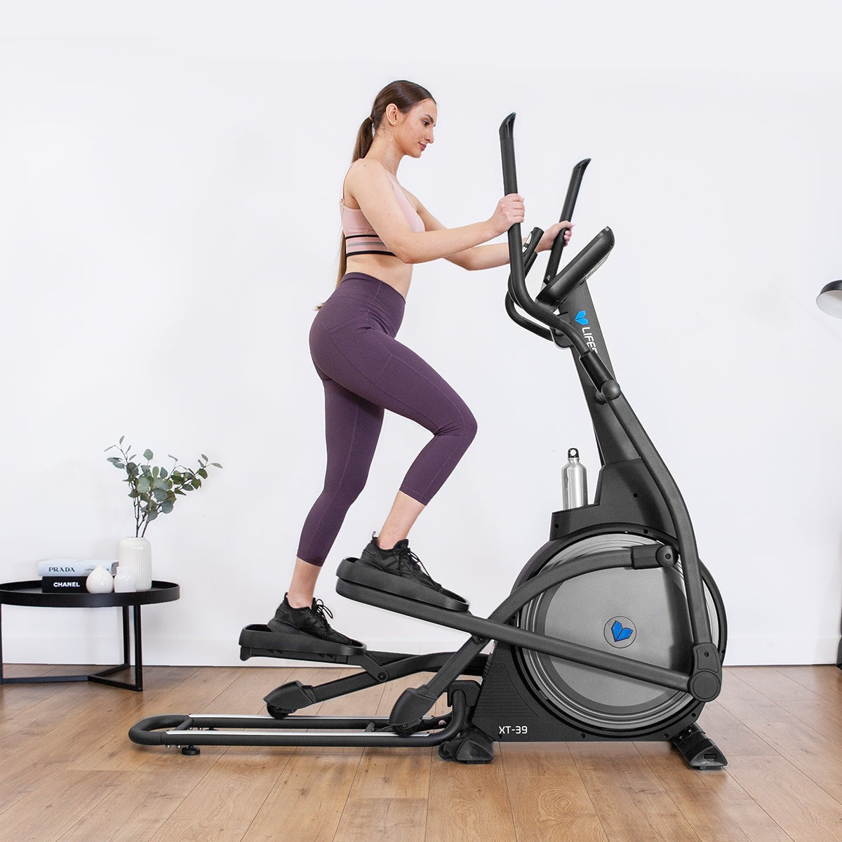 Lifespan Fitness XT-39 Folding Cross Trainer with a woman exercising, featuring an ergonomic design, adjustable resistance, and a compact foldable frame for home workouts.