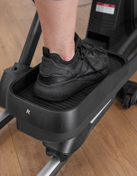 Close-up of a foot on the pedal of the Lifespan Fitness XT-39 Folding Cross Trainer, showcasing its ergonomic design for effective low-impact workouts.