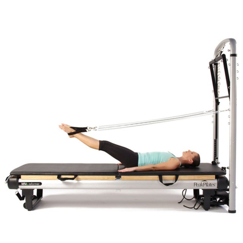 Peak Pilates MVe® Reformer and Tower with person using