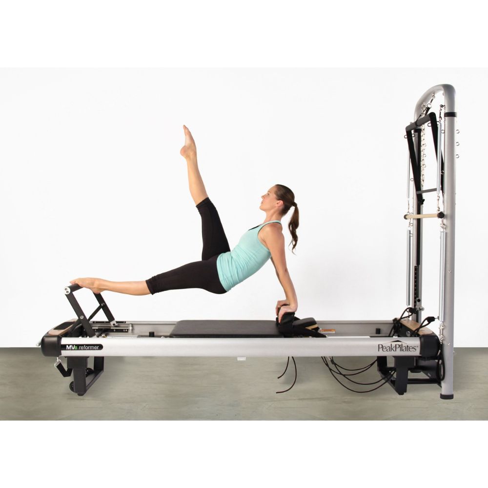 Peak Pilates MVe® Reformer and Tower with person using