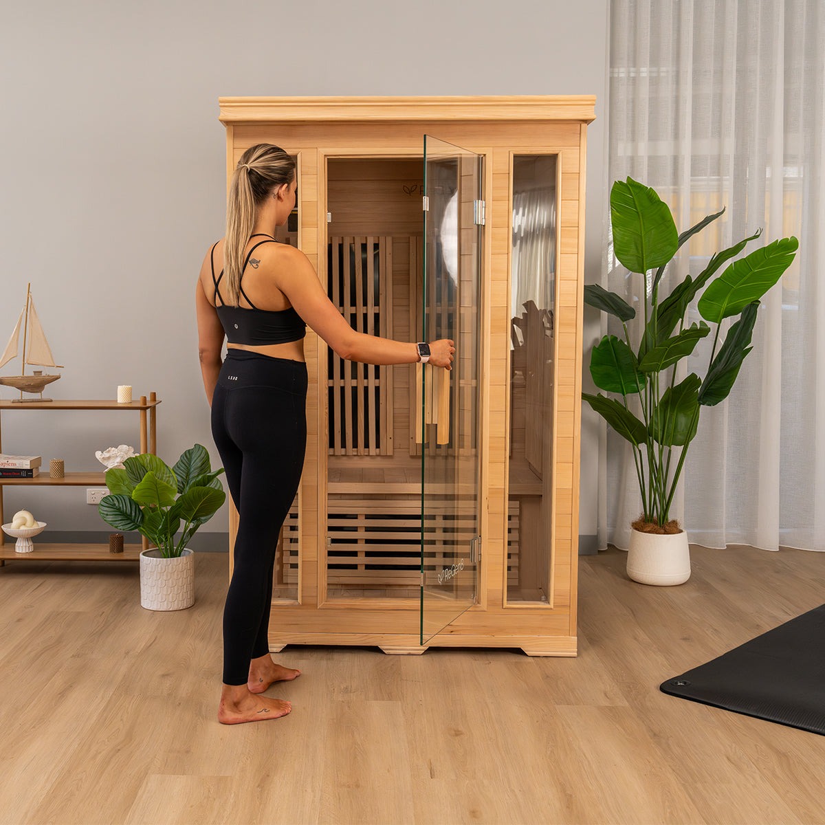 ReGen8 infrared sauna with glass doors and wooden interior in a modern room