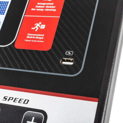 Modern treadmill in a stylish home gym with a young woman checking her phone