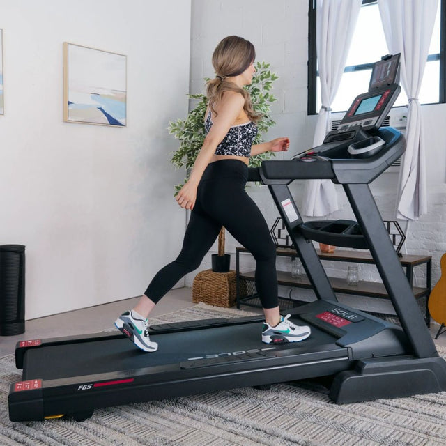 Sole F85 treadmill with digital console and safety key in a modern home setting