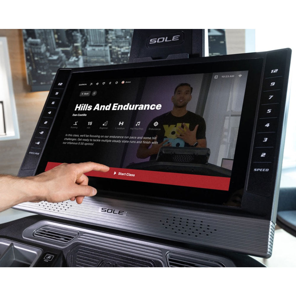 sole f89 treadmill person using touchscreen